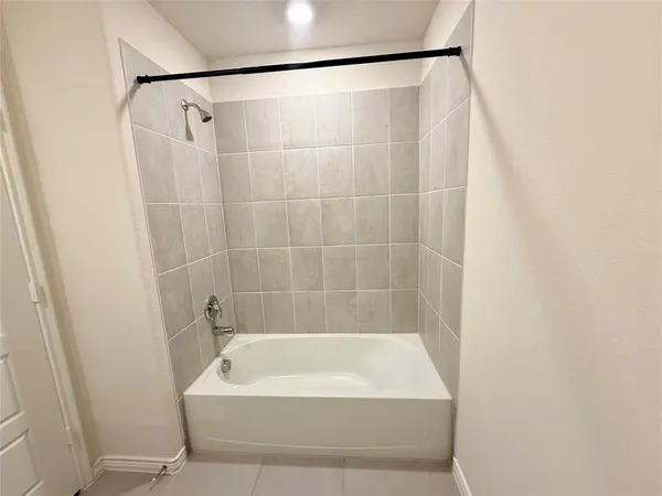 a bathroom with a shower and a bath tub