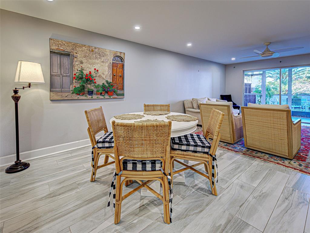 260 Santa Maria Street, Unit 109 Venice, FL 34285 - Photo 13 of 64 a dining room with furniture a floor to ceiling window and wooden floor