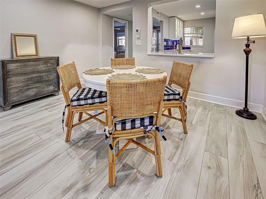 260 Santa Maria Street, Unit 109 Venice, FL 34285 - Photo 14 of 64 a view of a dining room with furniture and wooden floor