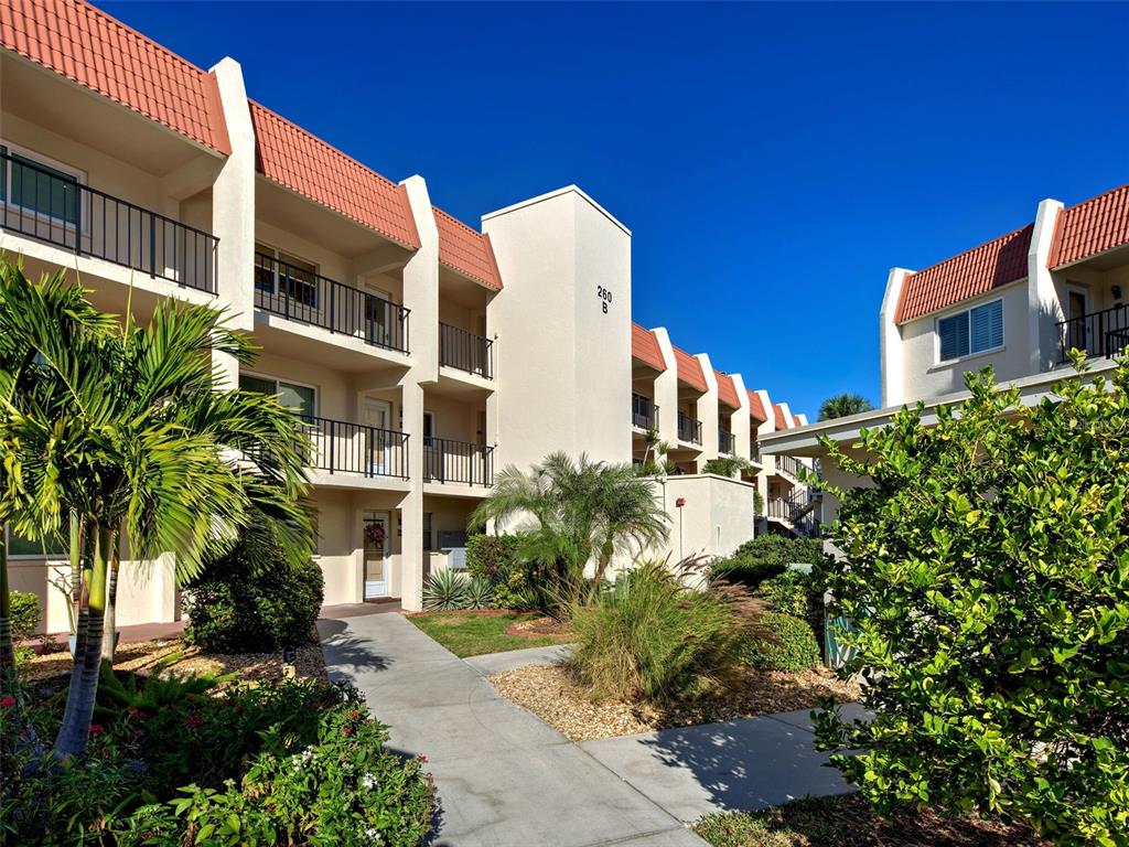 260 Santa Maria Street, Unit 109 Venice, FL 34285 - Photo 21 of 64 a front view of a multi story building with yard
