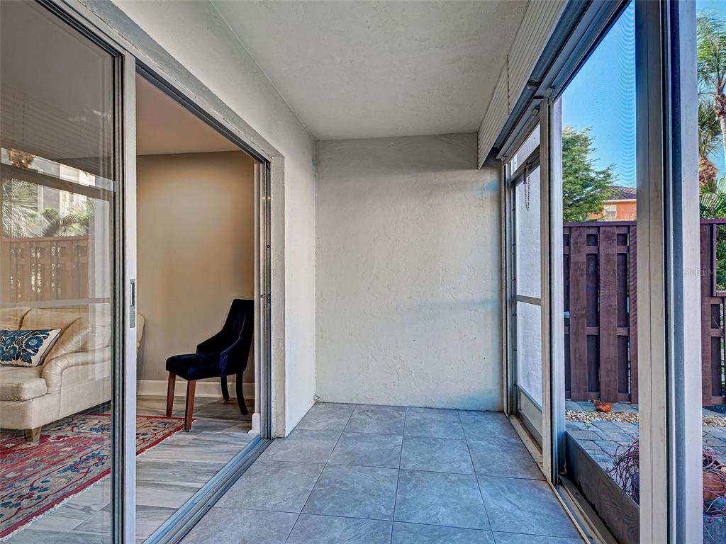 260 Santa Maria Street, Unit 109 Venice, FL 34285 - Photo 23 of 64 a view of a hallway with wooden floor and furniture