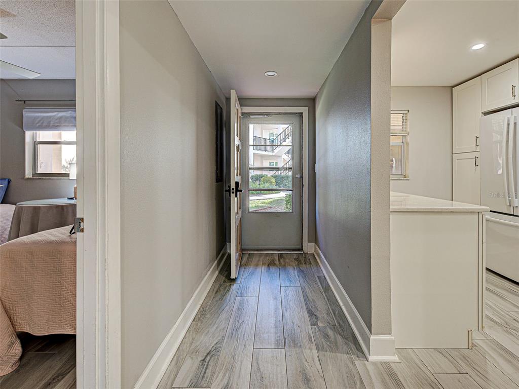 260 Santa Maria Street, Unit 109 Venice, FL 34285 - Photo 25 of 64 a view of a hallway view with wooden floor and staircase
