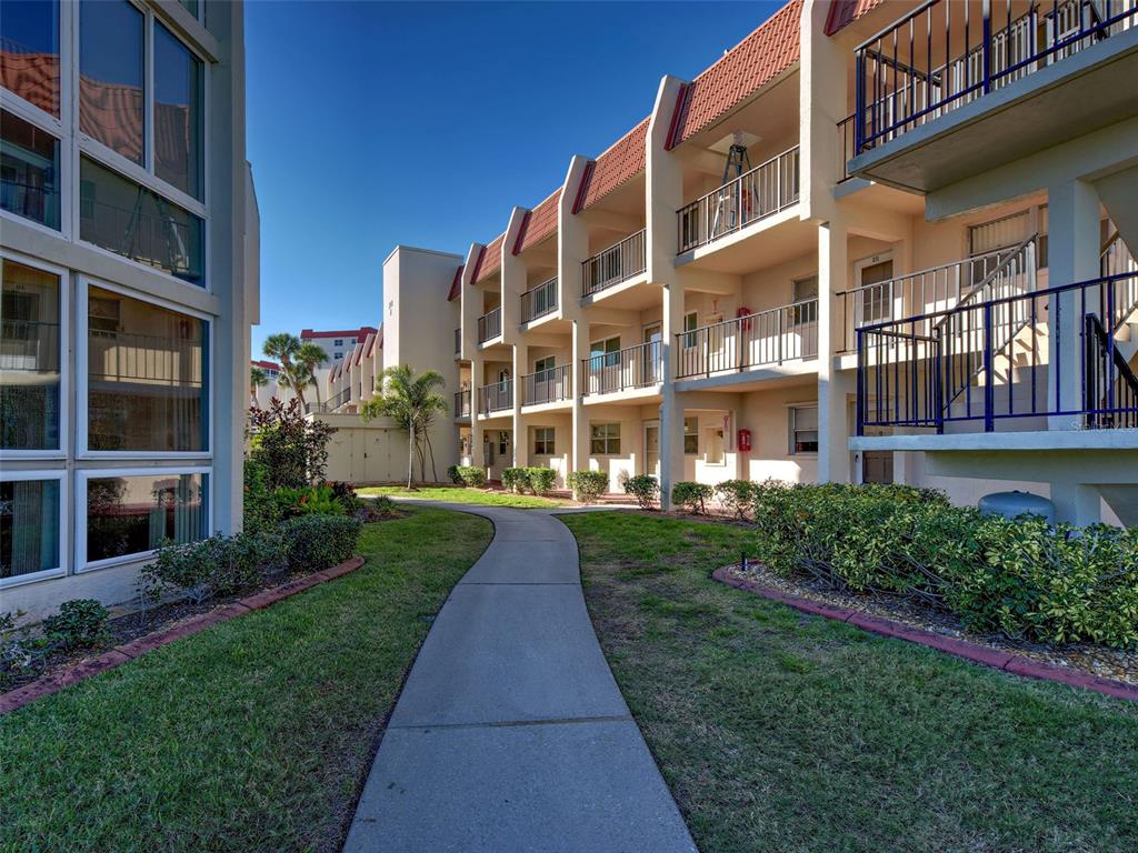 260 Santa Maria Street, Unit 109 Venice, FL 34285 - Photo 26 of 64 a view of a building with a yard