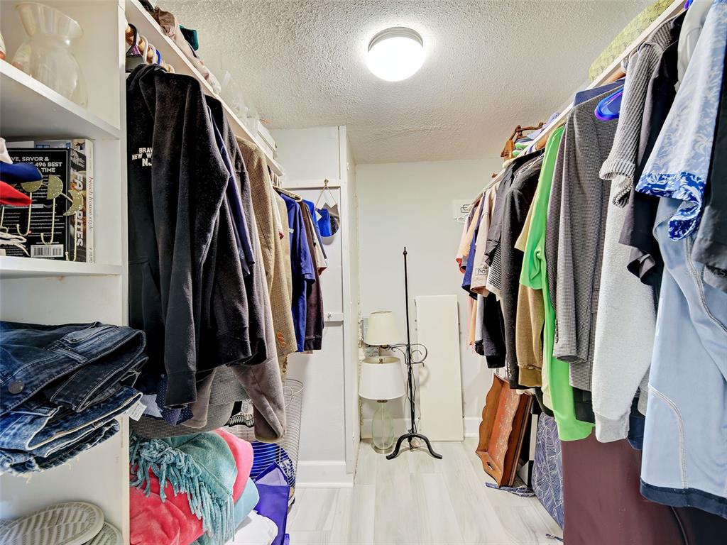 260 Santa Maria Street, Unit 109 Venice, FL 34285 - Photo 33 of 64 a view of walk in closet with clothes and shoes
