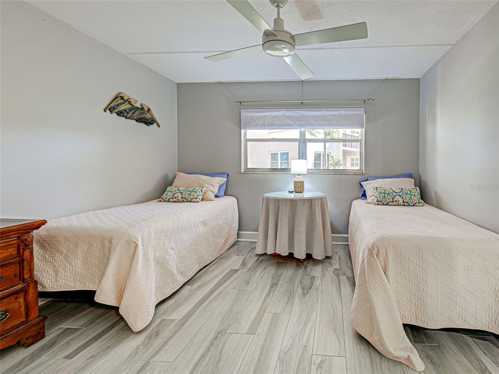 260 Santa Maria Street, Unit 109 Venice, FL 34285 - Photo 37 of 64 a bedroom with a bed and wooden floor