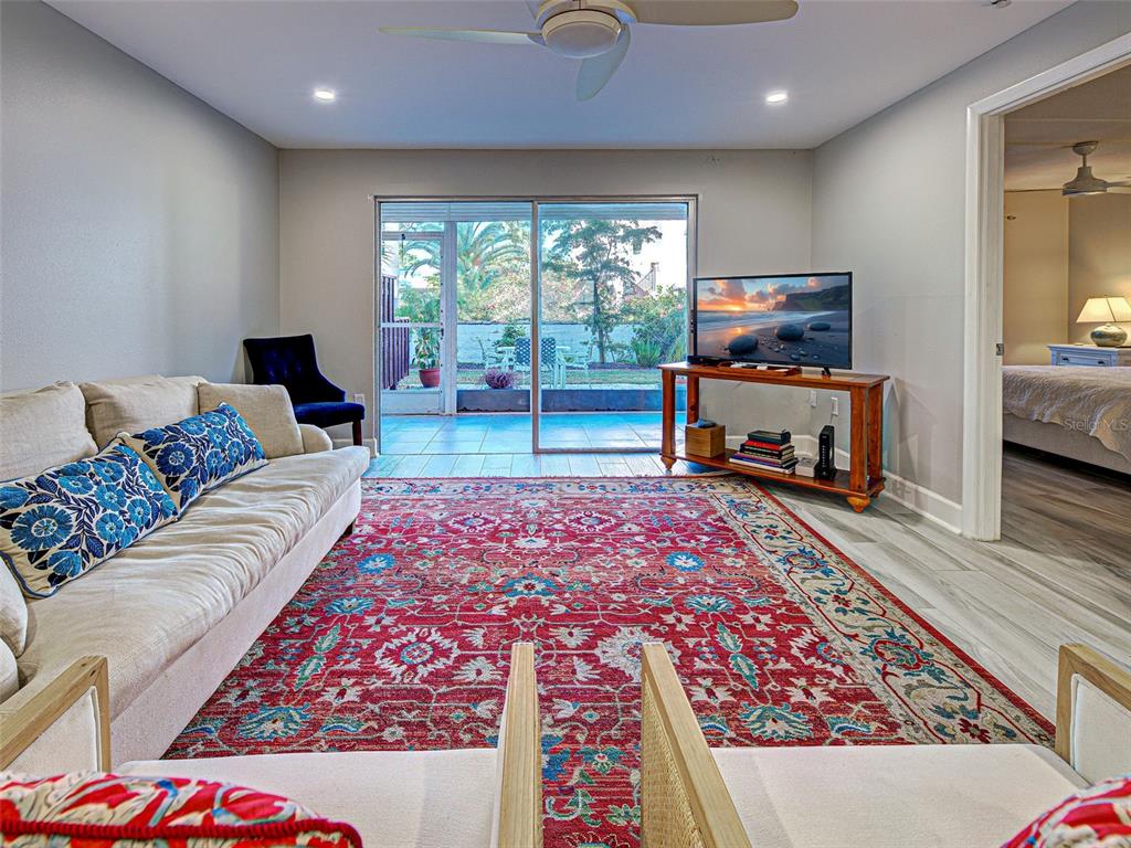 260 Santa Maria Street, Unit 109 Venice, FL 34285 - Photo 5 of 64 a living room with furniture and a flat screen tv