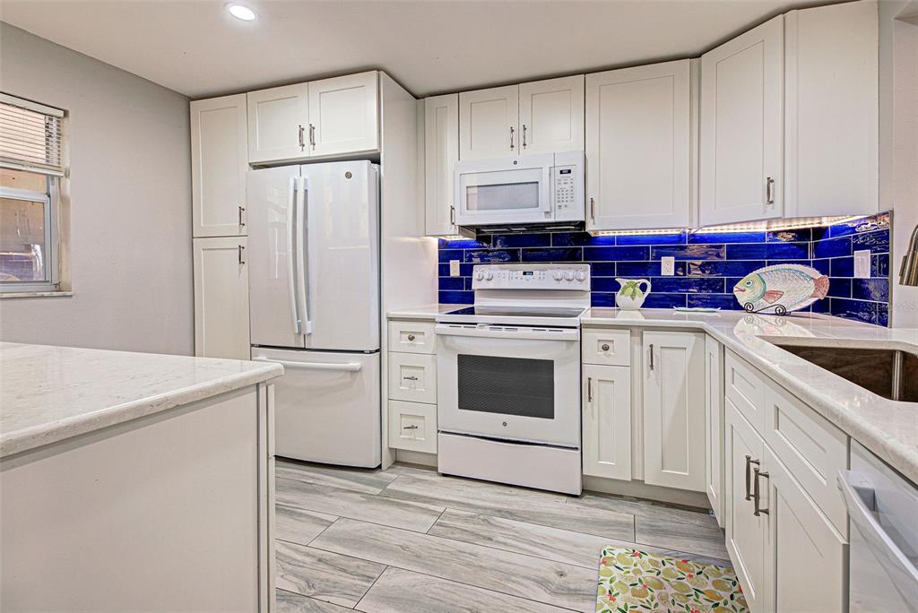 260 Santa Maria Street, Unit 109 Venice, FL 34285 - Photo 6 of 64 a kitchen with cabinets appliances and a sink