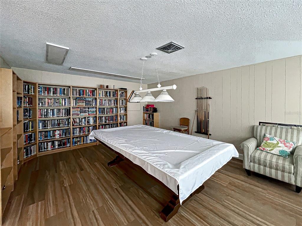 260 Santa Maria Street, Unit 109 Venice, FL 34285 - Photo 63 of 64 a bed room with a bed window and a chandelier