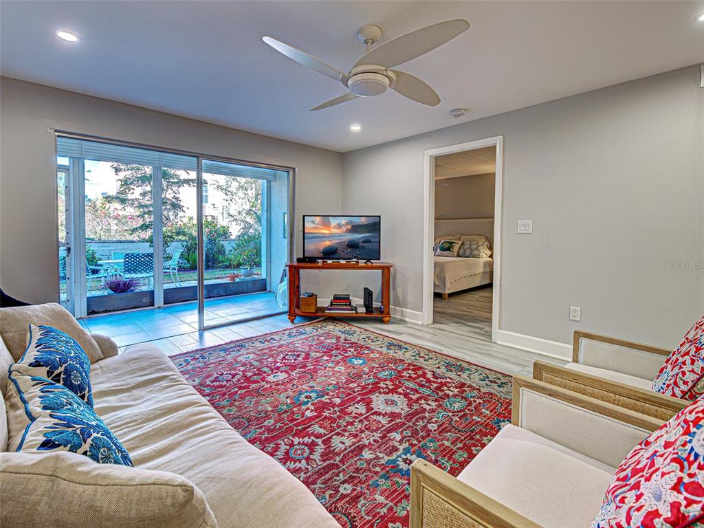 260 Santa Maria Street, Unit 109 Venice, FL 34285 - Photo 8 of 64 a living room with furniture and a flat screen tv