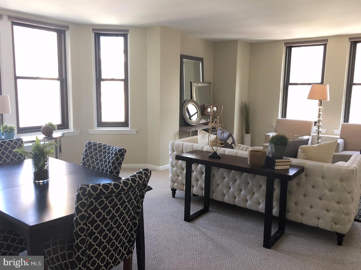 135 South 19th Street, Unit 804 Philadelphia, PA 19103 - Photo 2 of 18 a living room with furniture and a large window