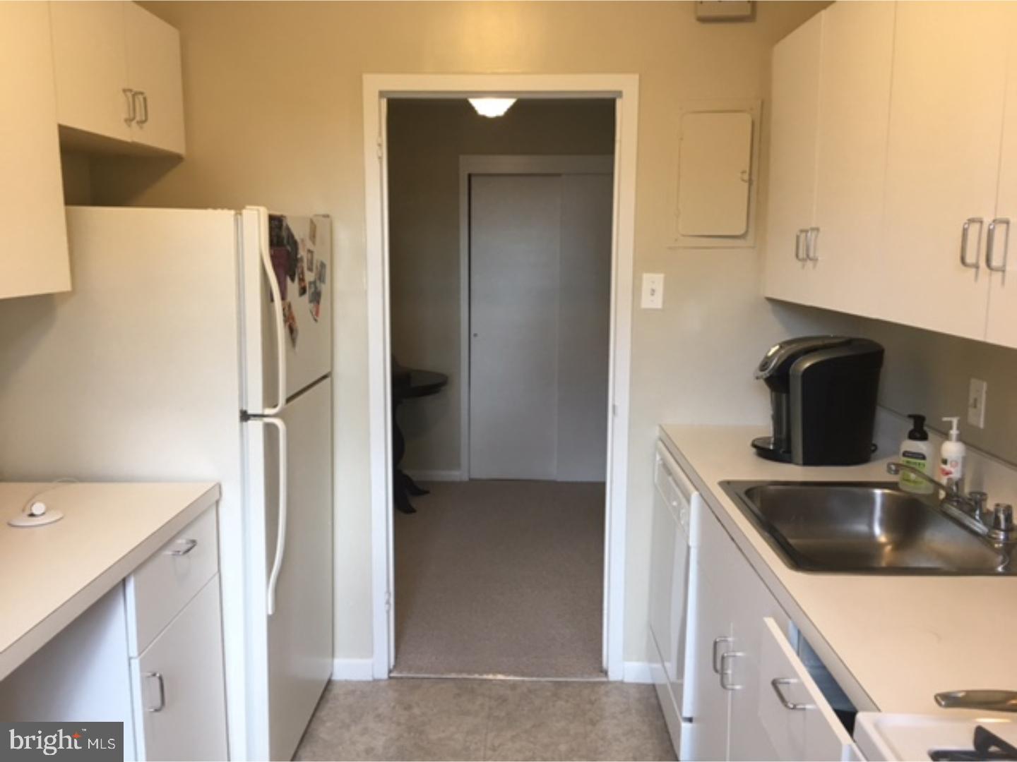 135 South 19th Street, Unit 804 Philadelphia, PA 19103 - Photo 6 of 18 a kitchen with a sink and a refrigerator