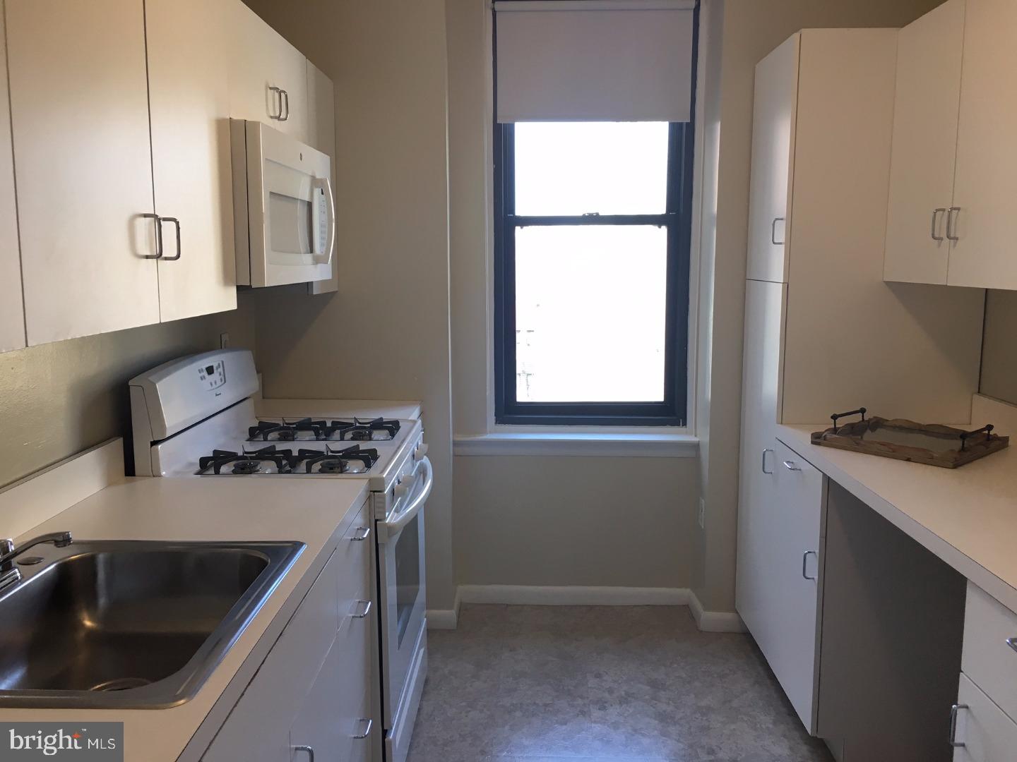 135 South 19th Street, Unit 804 Philadelphia, PA 19103 - Photo 7 of 18 a kitchen that has a sink and a stove