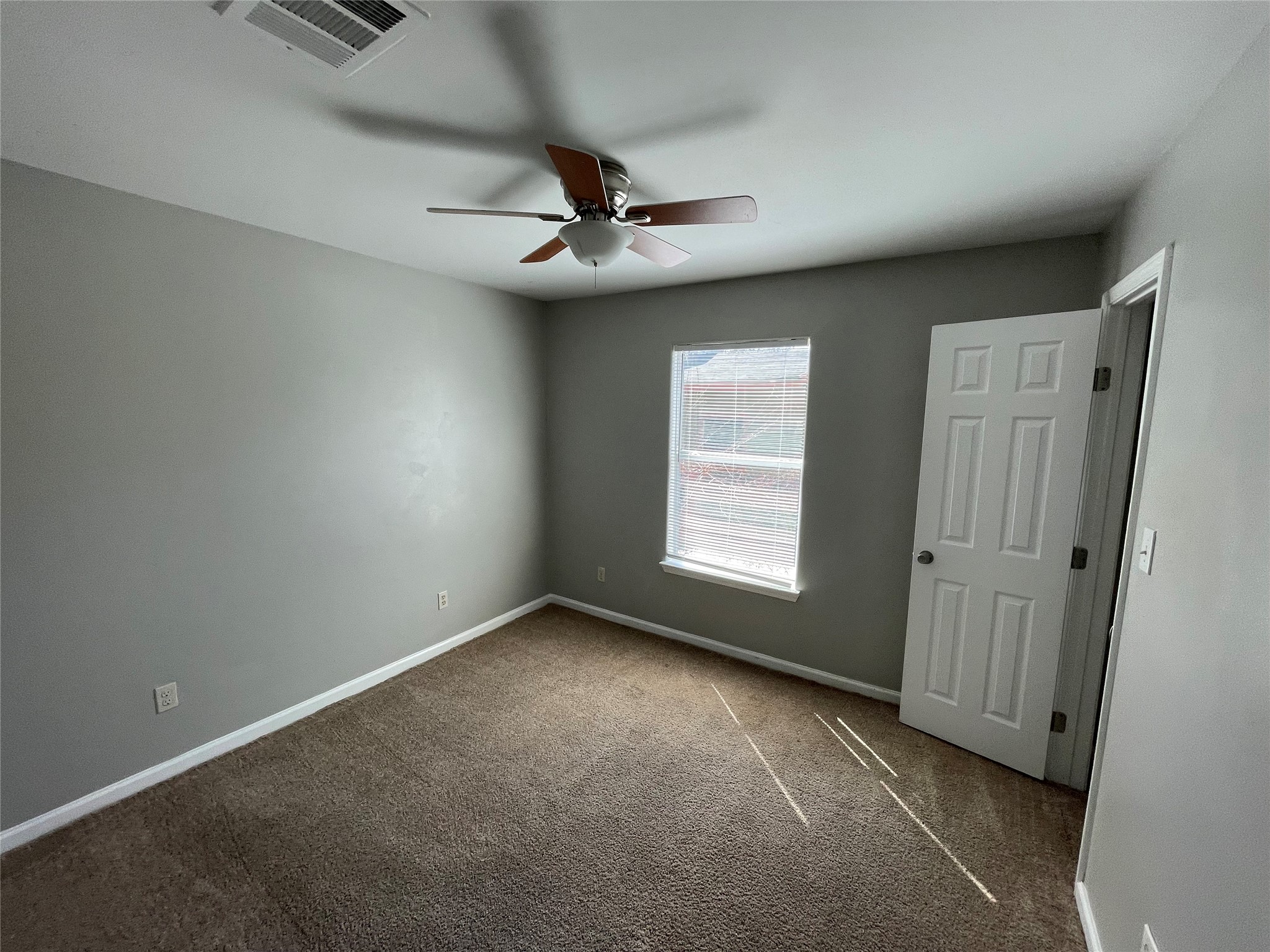 1041 Lott Avenue Austin, TX 78721 - Photo 11 of 14 an empty room with windows and fan