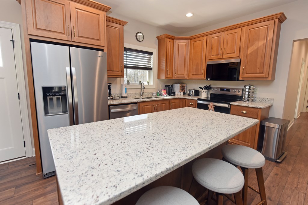 1008 Ridge Drive Morganton, GA 30560 - Photo 12 of 54 a kitchen with stainless steel appliances granite countertop a table chairs stove refrigerator and cabinets