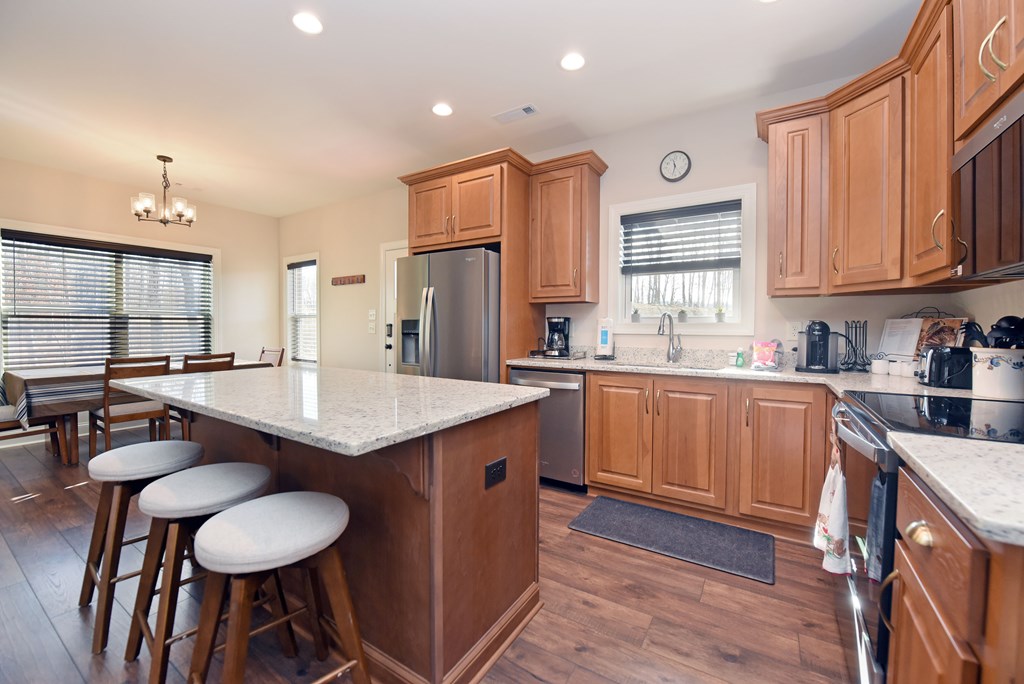 1008 Ridge Drive Morganton, GA 30560 - Photo 13 of 54 a kitchen with stainless steel appliances granite countertop a sink a stove a refrigerator cabinets and chairs