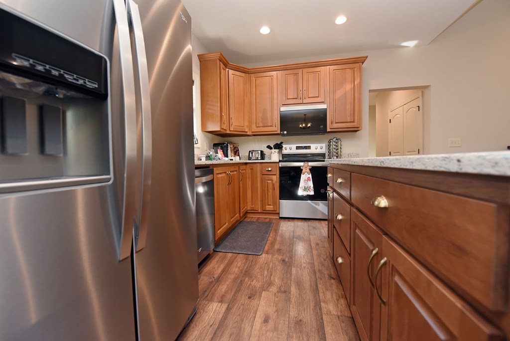 1008 Ridge Drive Morganton, GA 30560 - Photo 14 of 54 a kitchen with stainless steel appliances granite countertop a refrigerator a stove top oven a sink and dishwasher