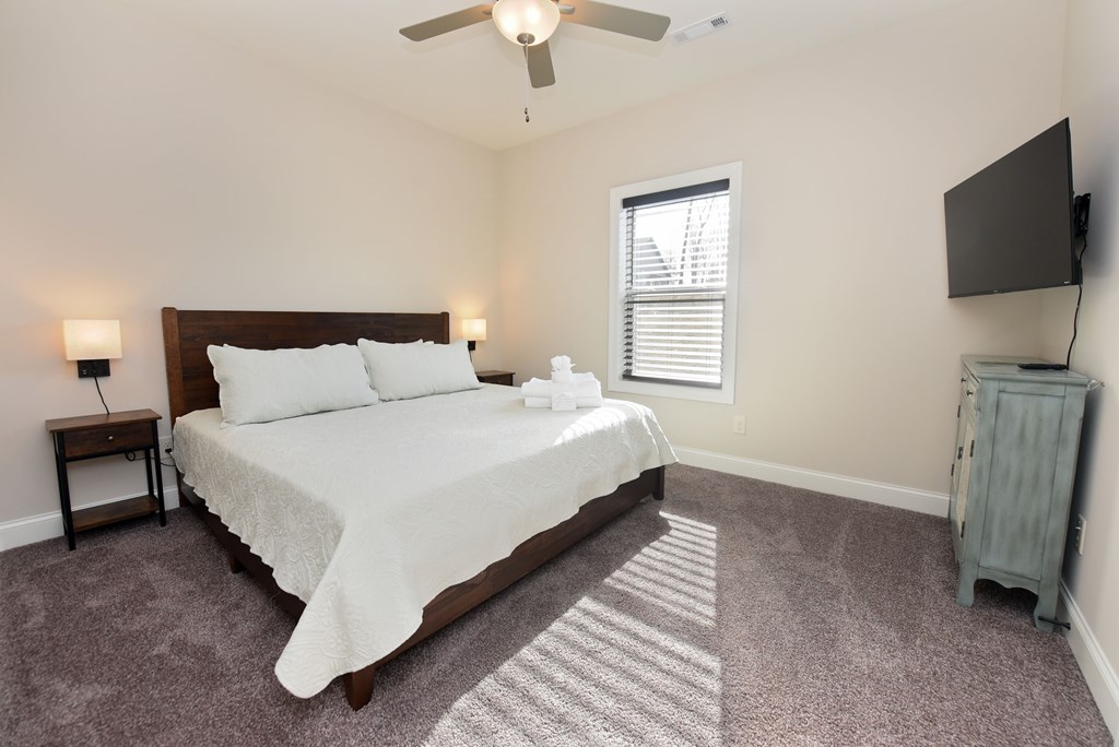 1008 Ridge Drive Morganton, GA 30560 - Photo 21 of 54 a spacious bedroom with a bed and a flat screen tv