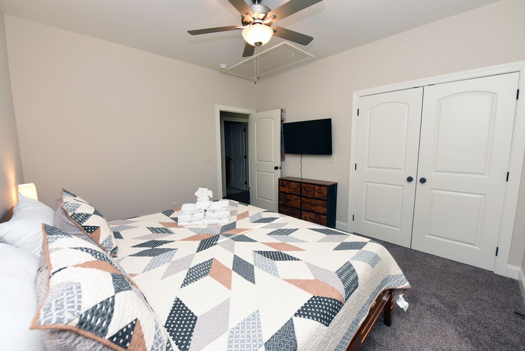 1008 Ridge Drive Morganton, GA 30560 - Photo 25 of 54 a bedroom with a bed and a flat screen tv