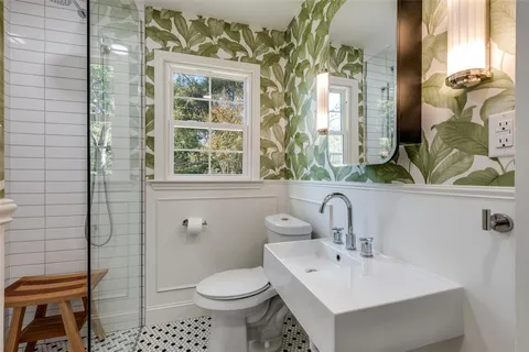 a bathroom with a sink toilet and shower