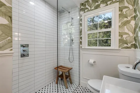 a bathroom with a toilet a sink and a shower