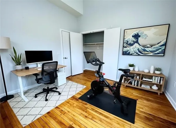 a view of a workspace with furniture and a rug