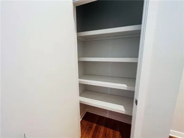 a view of walk in closet with empty racks