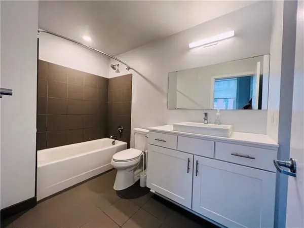 a bathroom with a sink a toilet and bathtub