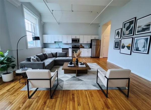 a living room with furniture and a wooden floor