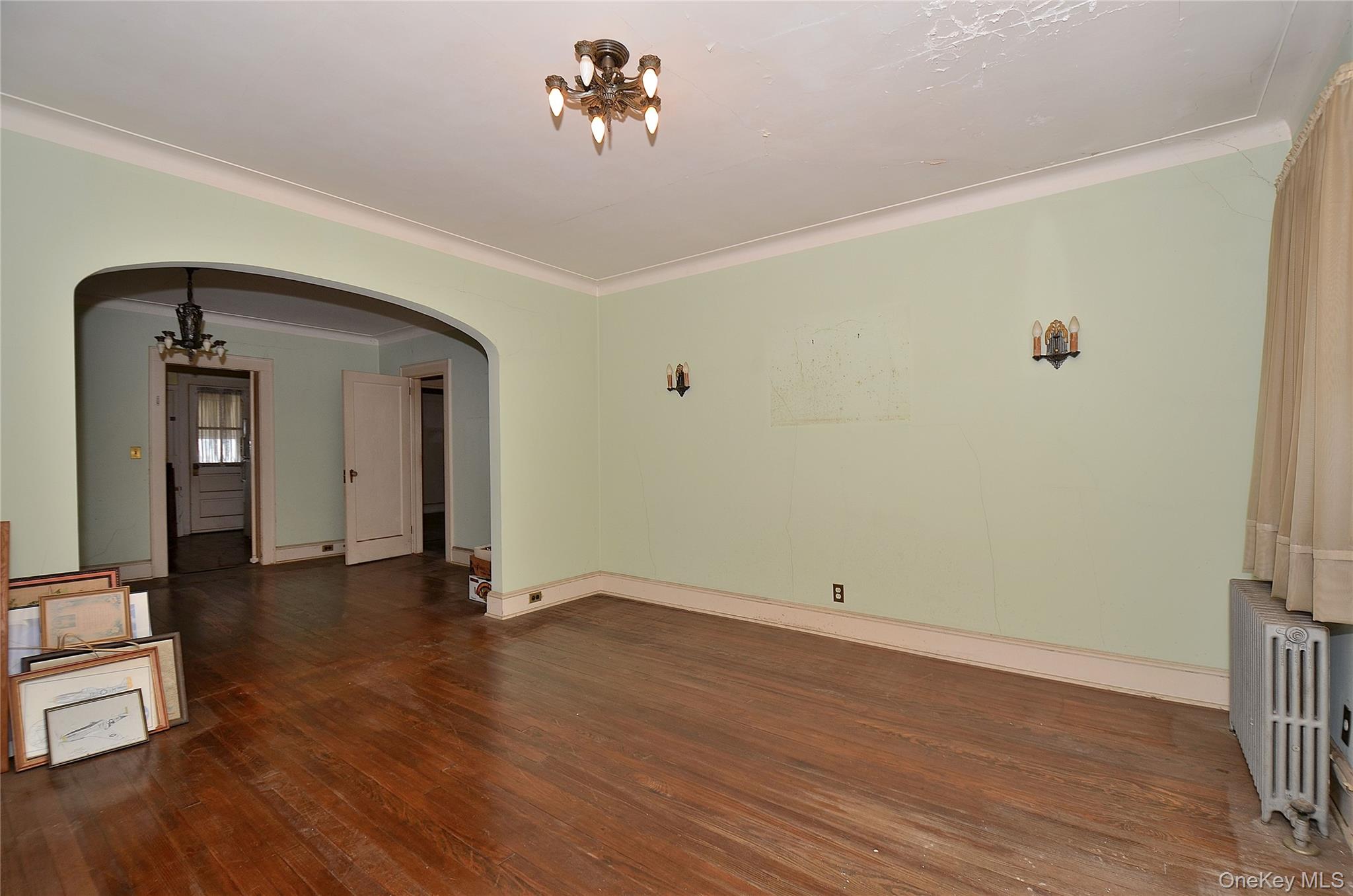 2586 Riverside Drive Wantagh, NY 11793 - Photo 8 of 28 Living Room featuring a solid wood door, hardwood flooring, and crown molding