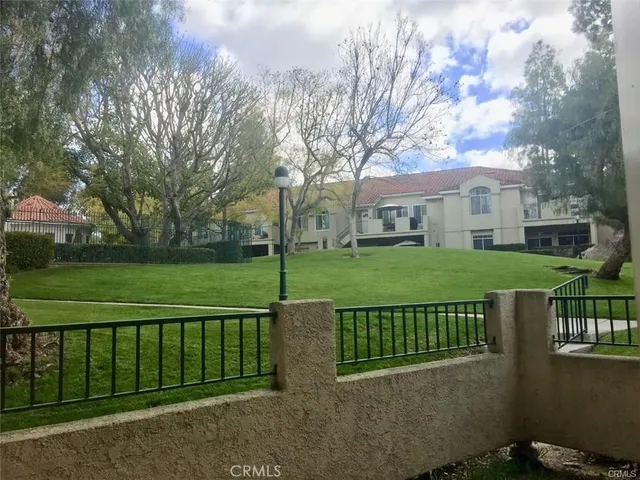 a view of a house with a deck area and garden