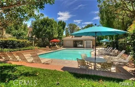 a view of a house with backyard and sitting area