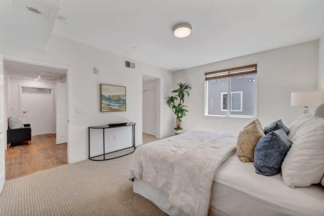 1421 Nightshade Road, Unit 40 Milpitas, CA 95035 - Photo 11 of 29 a bedroom with a large bed and a chandelier