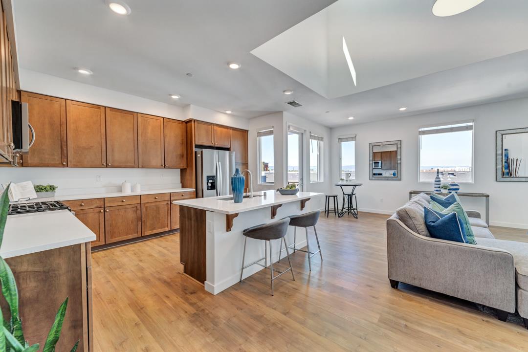 1421 Nightshade Road, Unit 40 Milpitas, CA 95035 - Photo 5 of 29 a living room with stainless steel appliances kitchen island granite countertop a couch and a view of living room