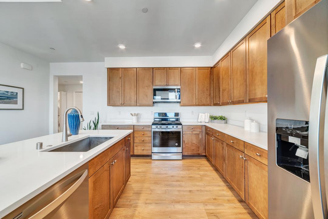 1421 Nightshade Road, Unit 40 Milpitas, CA 95035 - Photo 7 of 29 a large kitchen with stainless steel appliances granite countertop a stove sink and cabinets