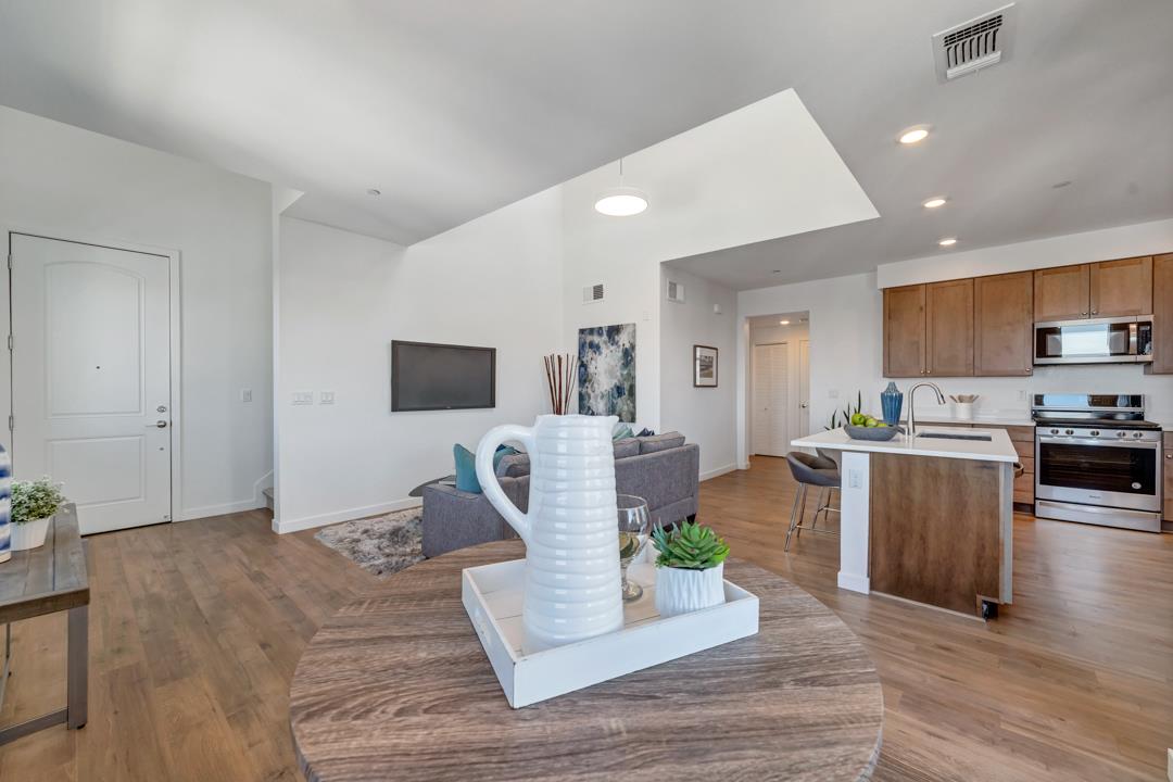 1421 Nightshade Road, Unit 40 Milpitas, CA 95035 - Photo 10 of 29 a living room with furniture wooden floor and a flat screen tv