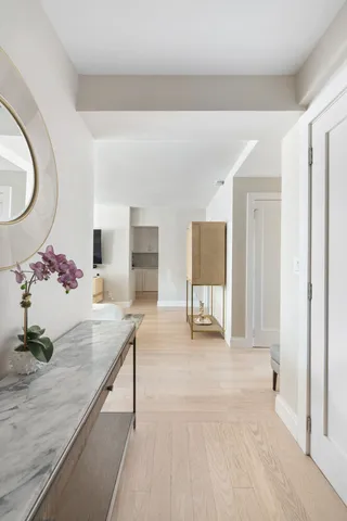 a kitchen with a dining table chairs and white cabinets