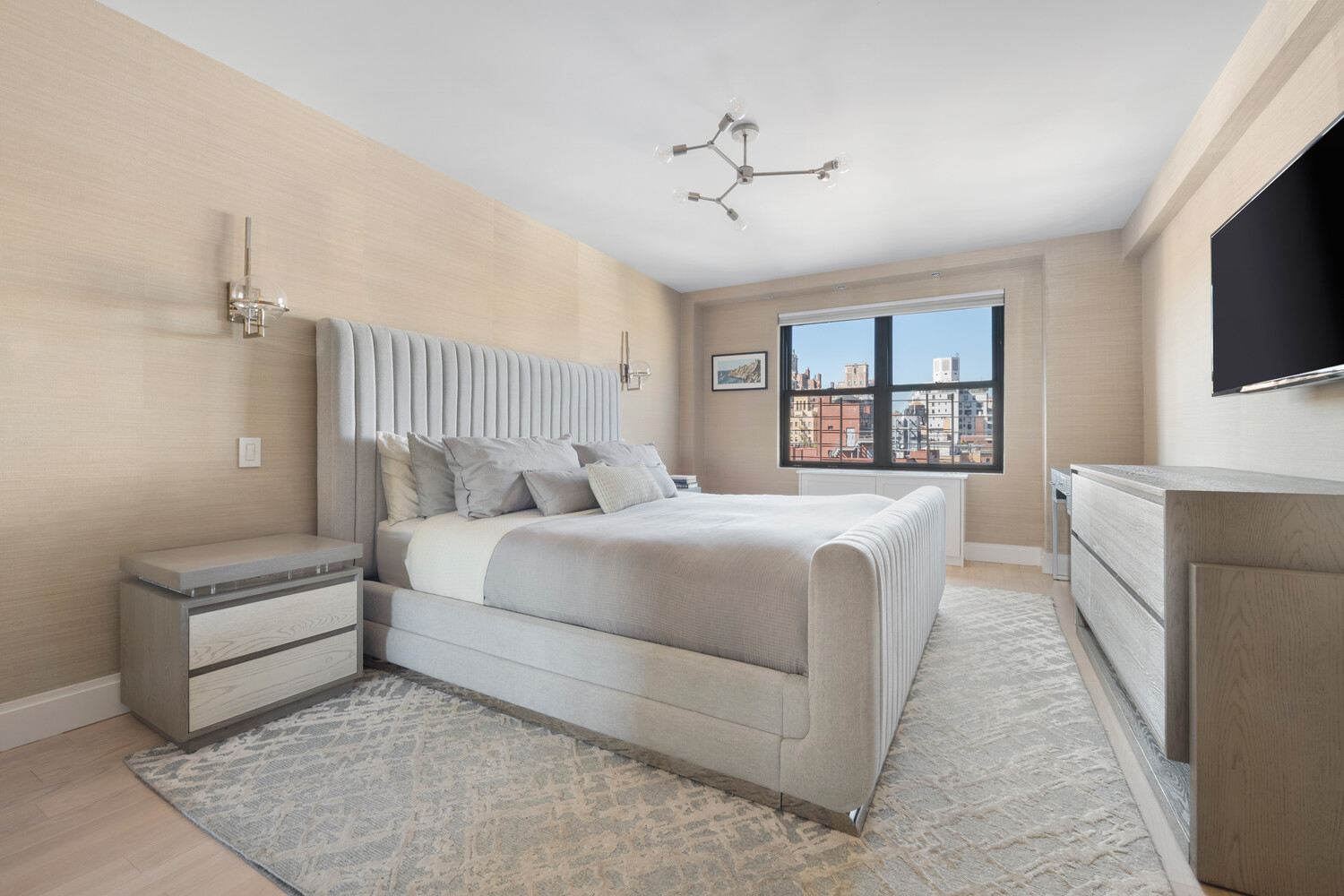 196 East 75th Street, Unit 16E Manhattan, NY 10021 - Photo 9 of 13 a bedroom with a large bed and a flat screen tv