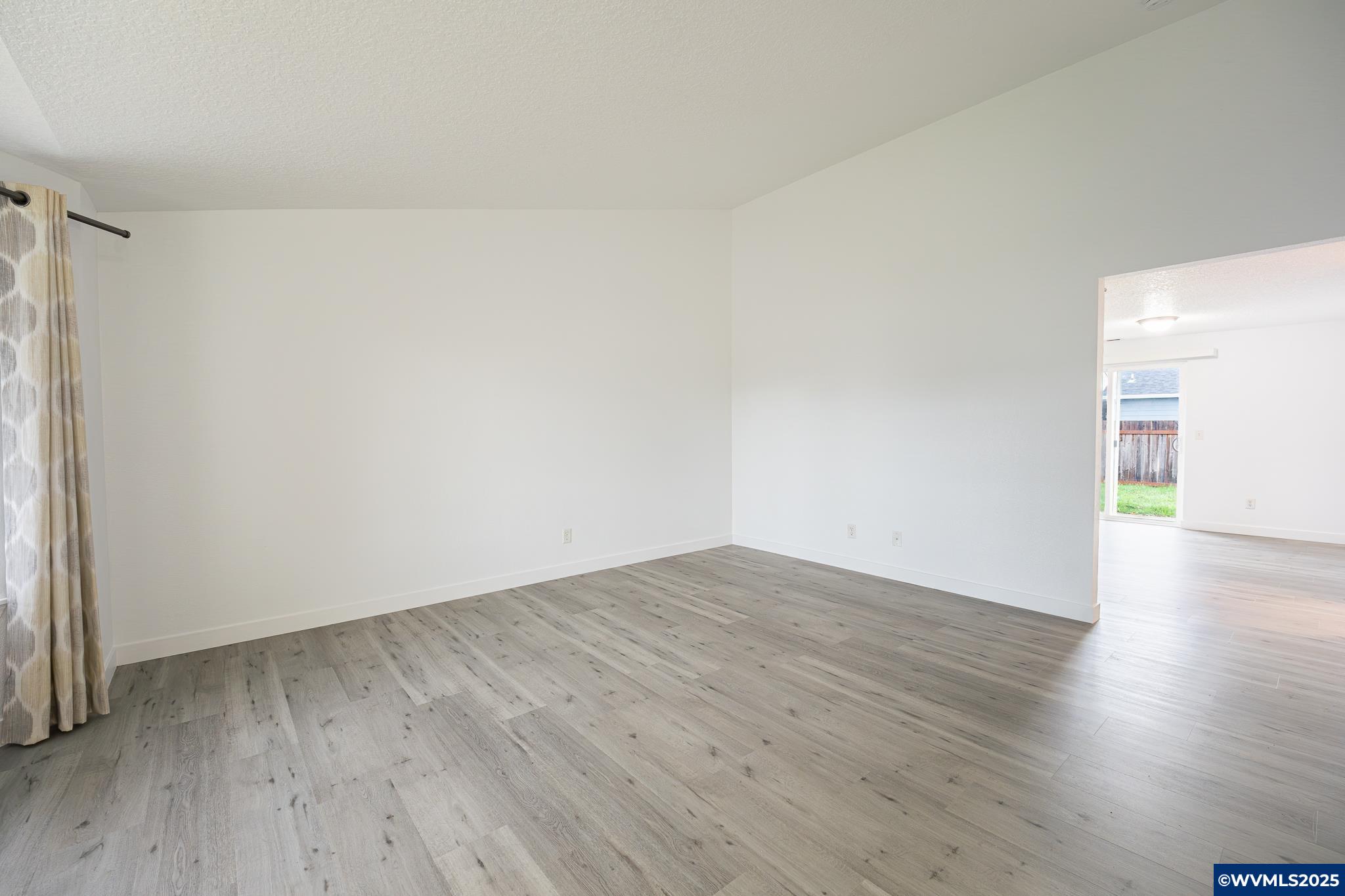 1467 South 7th Street Independence, OR 97351 - Photo 2 of 31 a view of an empty room with wooden floor and a window