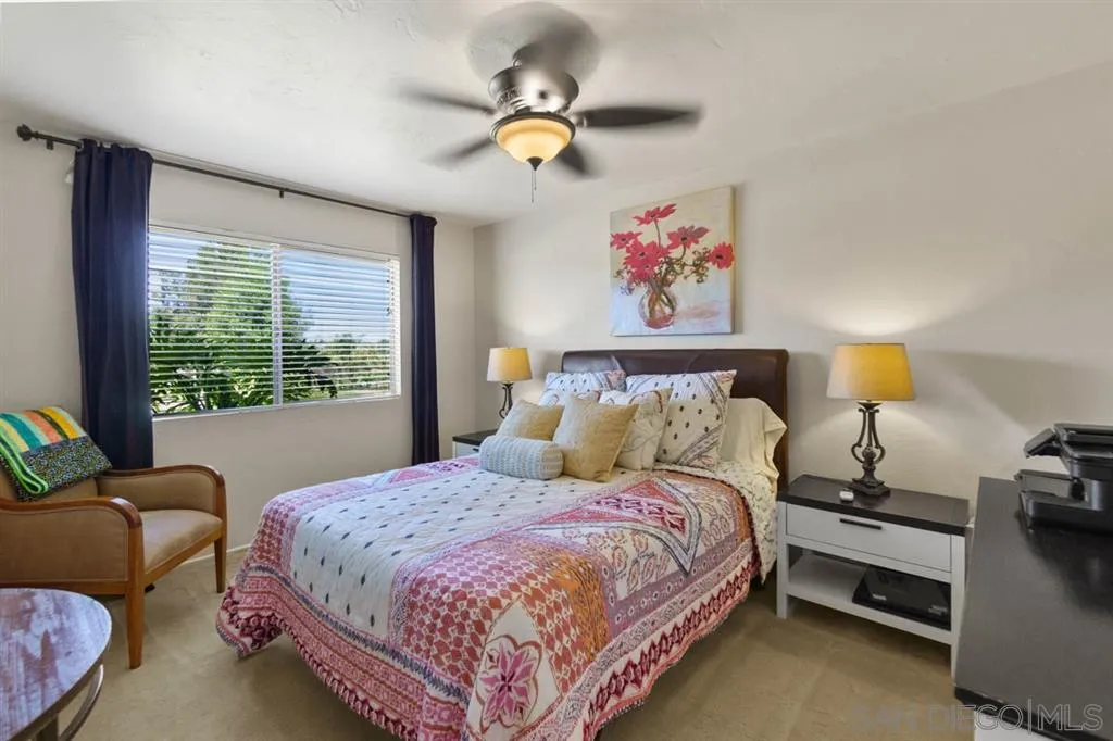 Encinitas, CA 92024 - Photo 11 of 12 a bedroom with a bed and a chandelier