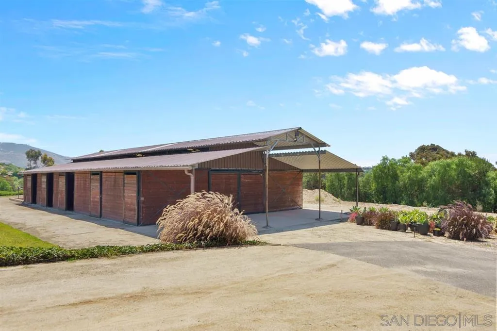 Encinitas, CA 92024 - Photo 4 of 12 front view of a house with a yard and garage