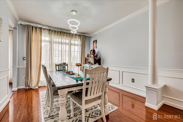 a bedroom with a large bed and a flat tv screen on dresser