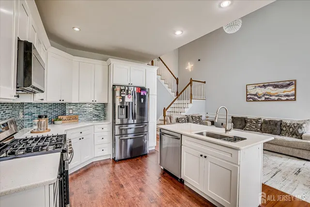 a bed sitting in a spacious bedroom next to a window