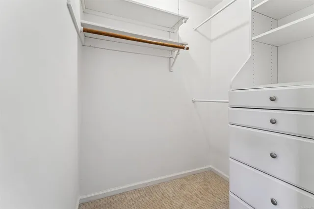 a bathroom with a granite countertop sink toilet and mirror