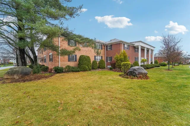 a view of staircase with railing and white walls