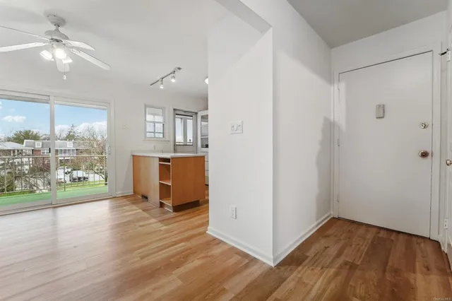 a view of a kitchen with wooden floor and a window