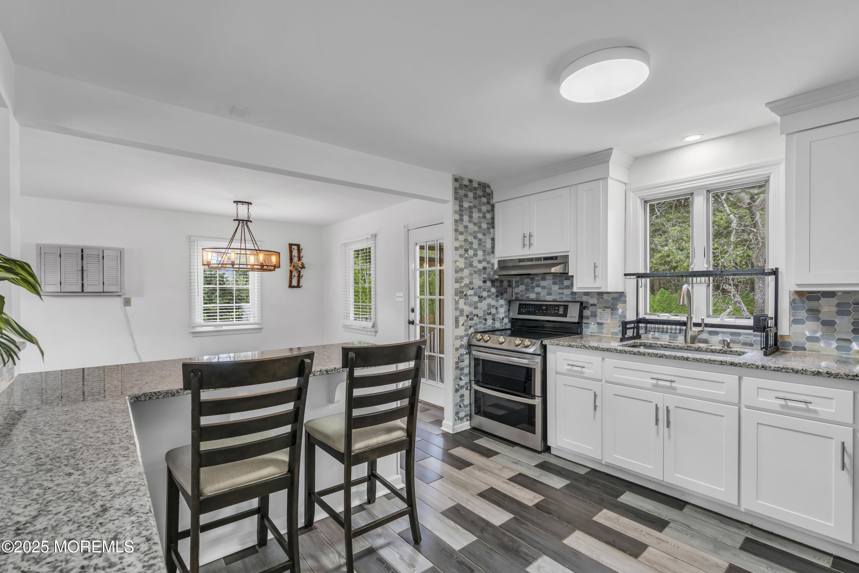 2 Schiverea Avenue Freehold, NJ 07728 - Photo 13 of 36 a kitchen with a stove a sink and a refrigerator