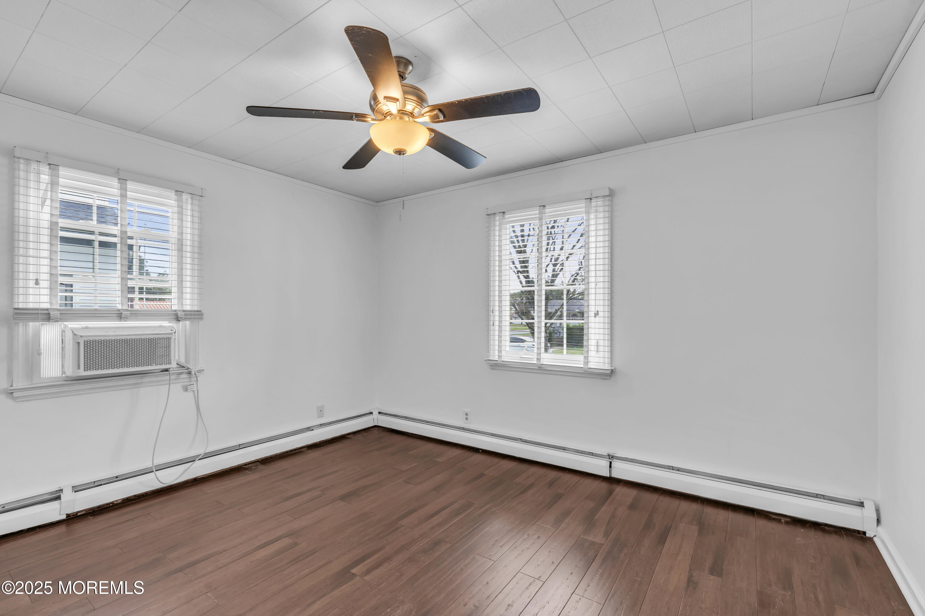 2 Schiverea Avenue Freehold, NJ 07728 - Photo 17 of 36 an empty room with wooden floor fan and windows