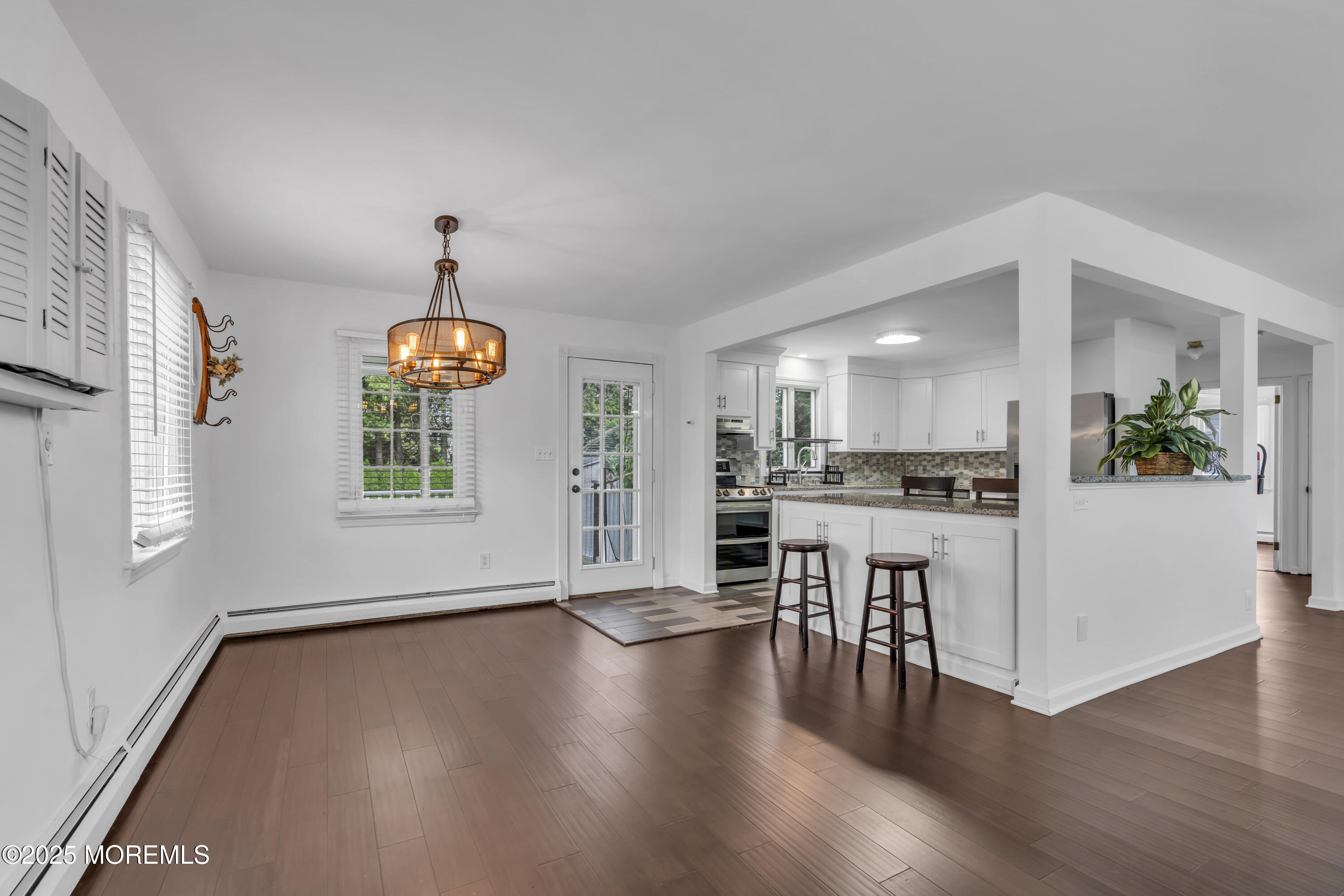 2 Schiverea Avenue Freehold, NJ 07728 - Photo 8 of 36 a view of an empty room and kitchen with wooden floor