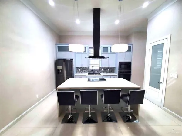 a kitchen with a table chairs sink and cabinets