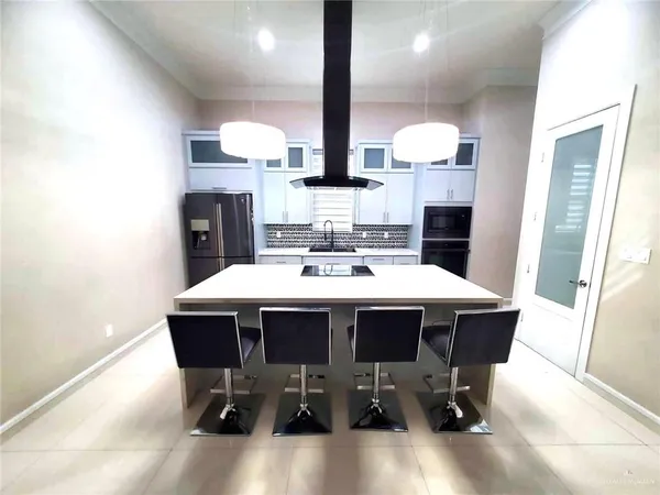 a view of a dining room with furniture and chandelier